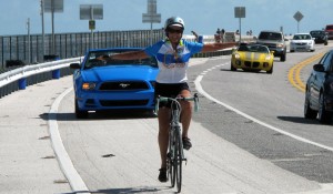 photo of Stacey riding over a bridge with no hands on handlebars