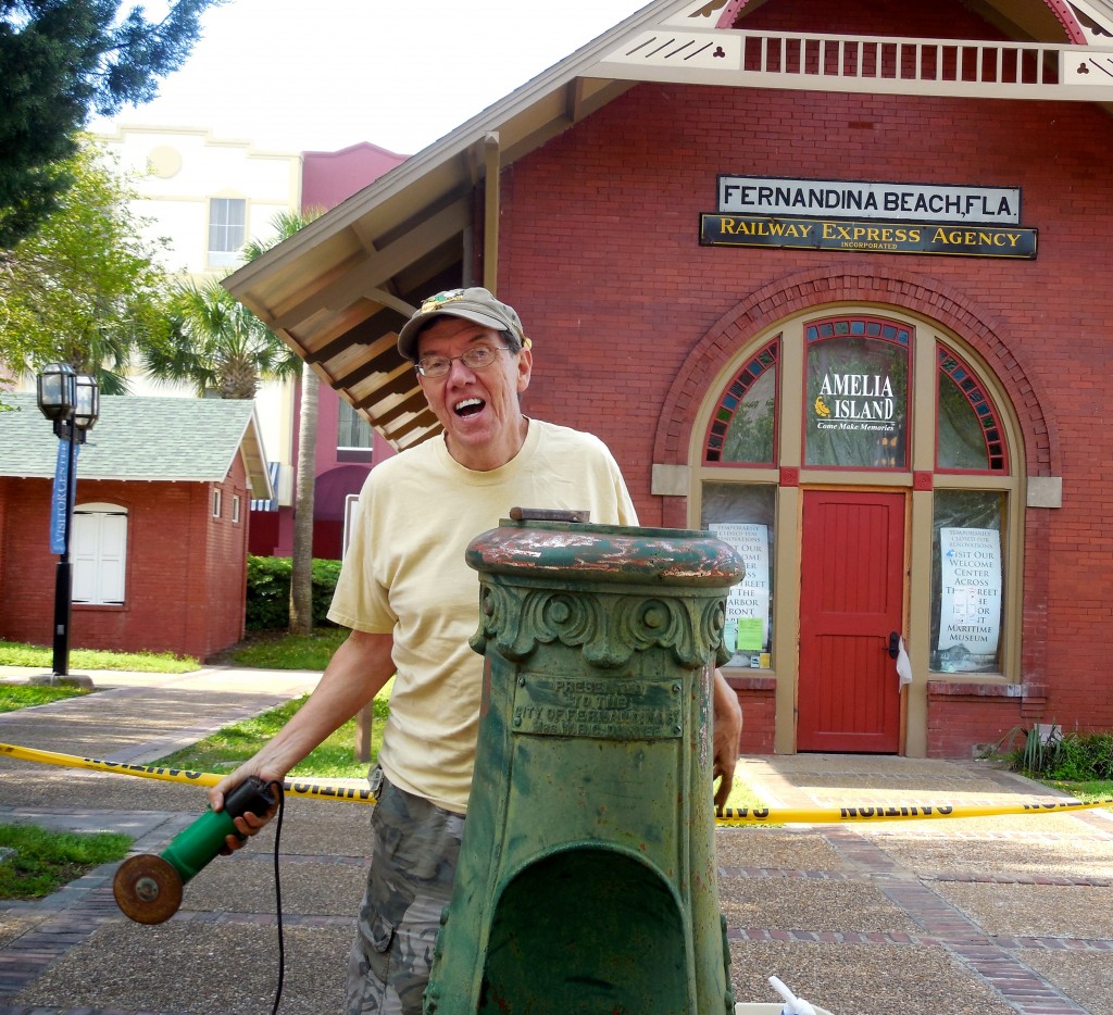 Local preservationist Chuck Hall removes decades of rust from the Duryee Fountain in front of the Train Depot.