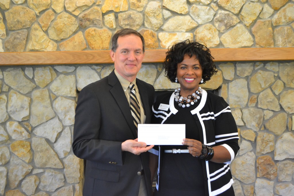Rayonier Advanced Materials Fernandina Plant General Manager C.A. McDonald presents a grant to Janice Ancrum of the Nassau County Council on Aging.