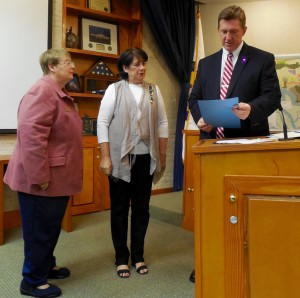 Jean Lay (l) and Diana Parfitt (c) listen to Mayor Ed Boner read their proclamation.
