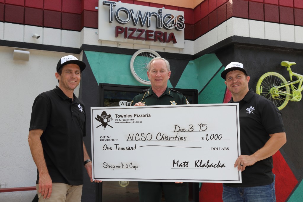 Townies Pizzeria Owner Matt Klabacka and Manager Robby Ward present Nassau County Sheriff Bill Leeper with a $1,000 ceremonial check to celebrate the "Italian street food" restaurant's support of local law enforcement in the community.